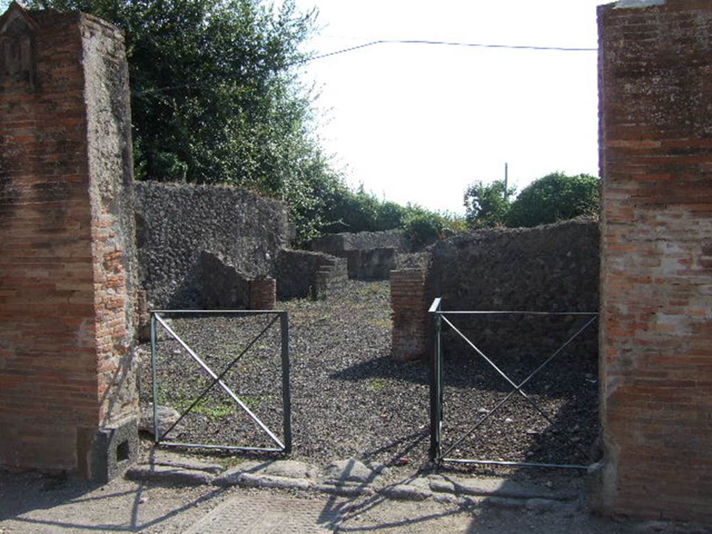 VI.17.3 Pompeii. September 2005. Looking west into entrance of caupona, and south-west to rear rooms linked to VI.17.4. For other photographs of rear rooms, see VI.17.4.
