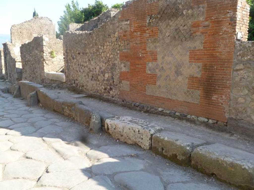 VI.17.10, on left, and VI.17.9, on right, Pompeii. May 2011. Looking south along wall between entrance doorways. Photo courtesy of Michael Binns.
