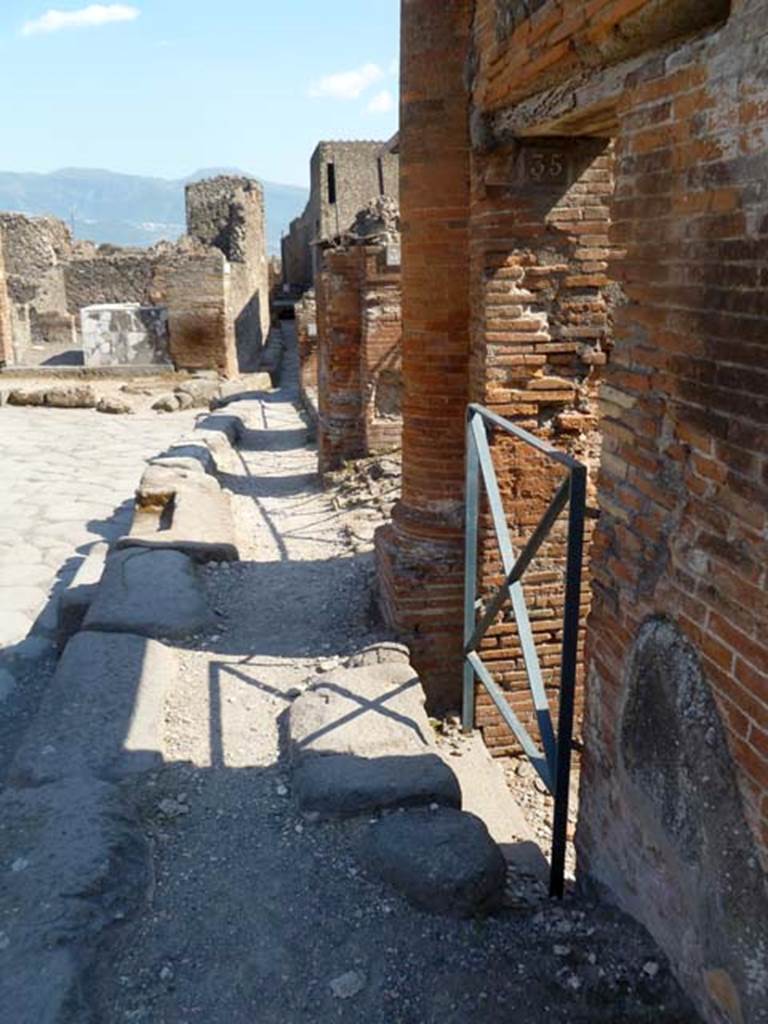 VI.17.35 Pompeii. May 2011. Looking south along pavement of Via Consolare from doorway.
Photo courtesy of Michael Binns.
