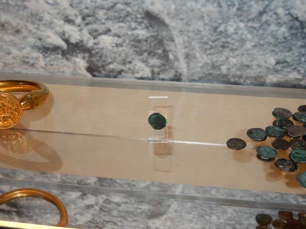 VI.17.42 Pompeii, May 2018. Detail of shelf with bracelet, single silver and pile of silver coins. 
Photo courtesy of Buzz Ferebee.
