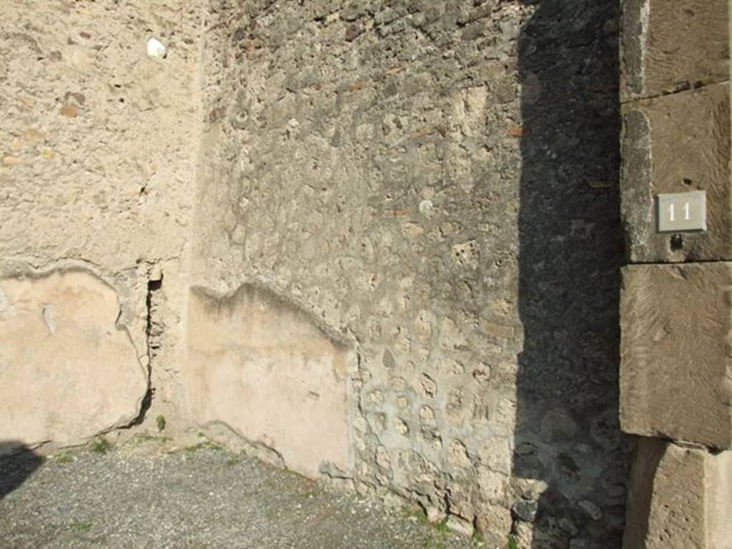VII.1.11 Pompeii. December 2007. East wall, with remains of downpipe in north-east corner.