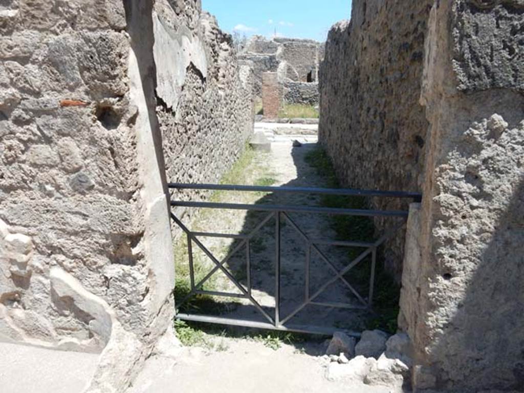 VII.1.18 Pompeii. May 2017. Looking east from room 21 of VII.1.47.
Looking through (no longer bricked-up) doorway (which has now been opened out) to entrance at VII.1.18, leading to Via Stabiana. 
Photo courtesy of Buzz Ferebee.

