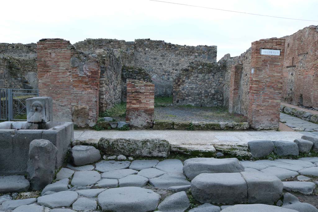 VII.1.33 Pompeii, on right of fountain, and VII.1.34 Pompeii, centre right. December 2018. 
Looking west towards entrance doorways. Photo courtesy of Aude Durand.

