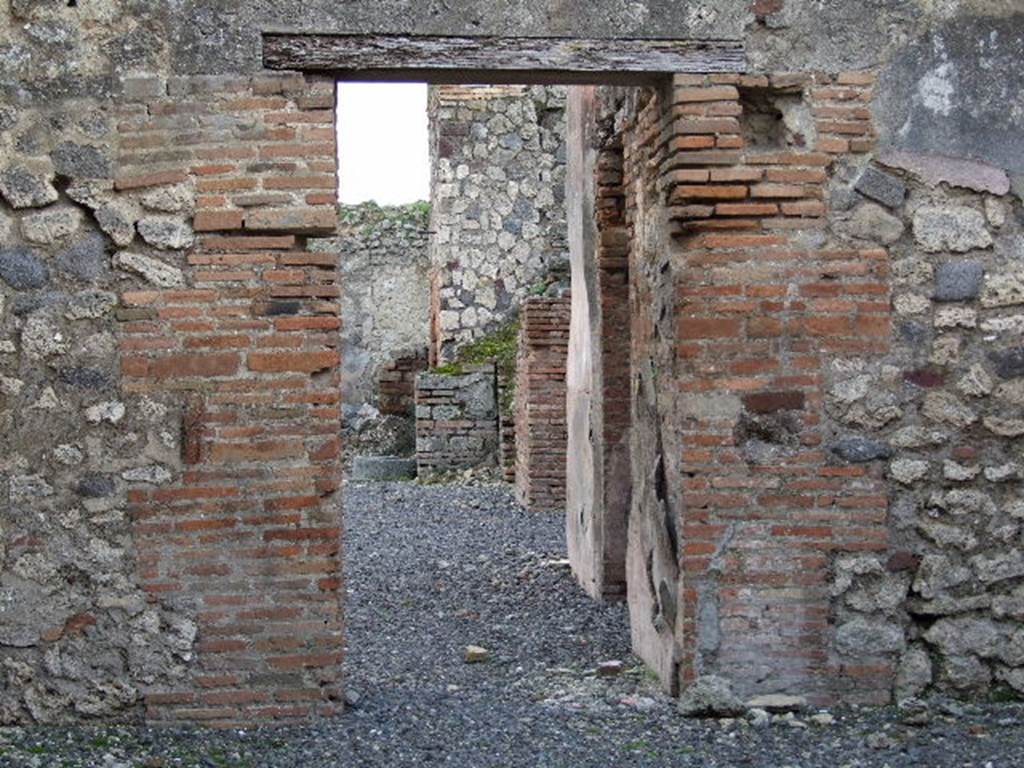 VII.1.36 Pompeii. October 2009. Looking towards south wall, with doorway to bakery at VII.1.36. Photo courtesy of Jared Benton.
