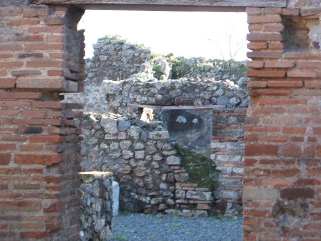 VII.1.37 Pompeii. December 2006. Line of staircase is visible on south wall, and doorway to bakery.