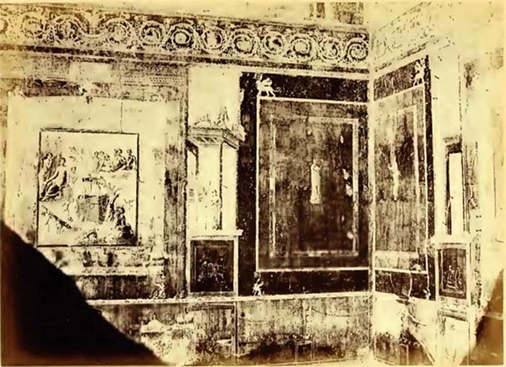 VII.1.47 Pompeii. 1867. Exedra 10 in north-east corner of atrium.  
According to Dyer:
“The spacious and lofty exedra in which these paintings are found, has a threshold of white mosaic bordered with black zones, with ornaments in the middle like shields, in the shape of a half-moon. The floor is painted with black fillets, except a piece of mosaic in the centre, in which are represented two diotae or double-handled wine jars, with shoots of vine which interlace and surround a rectangular piece of marble, formed of twenty-two squares of giallo antico. 
The walls, which are painted in yellow compartments on a red background, terminate above in a bold scroll border, within the spirals of which are depicted quadrupeds and winged cupids in various attitudes. Above this border, up to the roof, the walls are painted with pieces of architecture and other ornaments. 
The whole is surrounded by a small cornice supporting the roof, which is richly decorated with stuccoes and gilt bas-reliefs. 
The three paintings are upon a red background, and framed as it were in a meander in the fashion of a cornice, and adorned at the corners with fantastically shaped animals. 
At the sides of them are seen capricious pieces of architecture, on the top of which as on an acroterium, stand centaurs and beasts in ferocious attitudes. 
Those on each side of the painting of Hercules contain the image of Apollo Musagetes, with the bow and lyre (not seen in the photograph), and the Muse Calliope, with a roll of paper in her hand. 
The remaining Muses, painted on a yellow background with accurate execution and vivid colouring, decorate the other compartments of the exedra, together with some views of houses and landscapes. 
The podium, or part near the floor, is painted black and divided into square compartments, ornamented with festoons of plants attached to candelabra supporting spheres with aquatic plants, bucrania, or ox-heads, and Bacchic vases.”
See Dyer, T., 1867. The Ruins of Pompeii. London: Bell and Daldy. (p.82-83)
