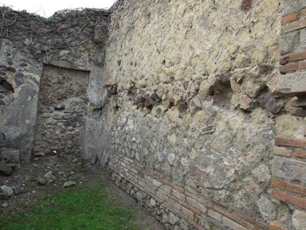 VII.2.13 Pompeii.  Shop with dwelling.  December 2007.  North wall, with walled up door to atrium of VII.2.14 in north west corner.