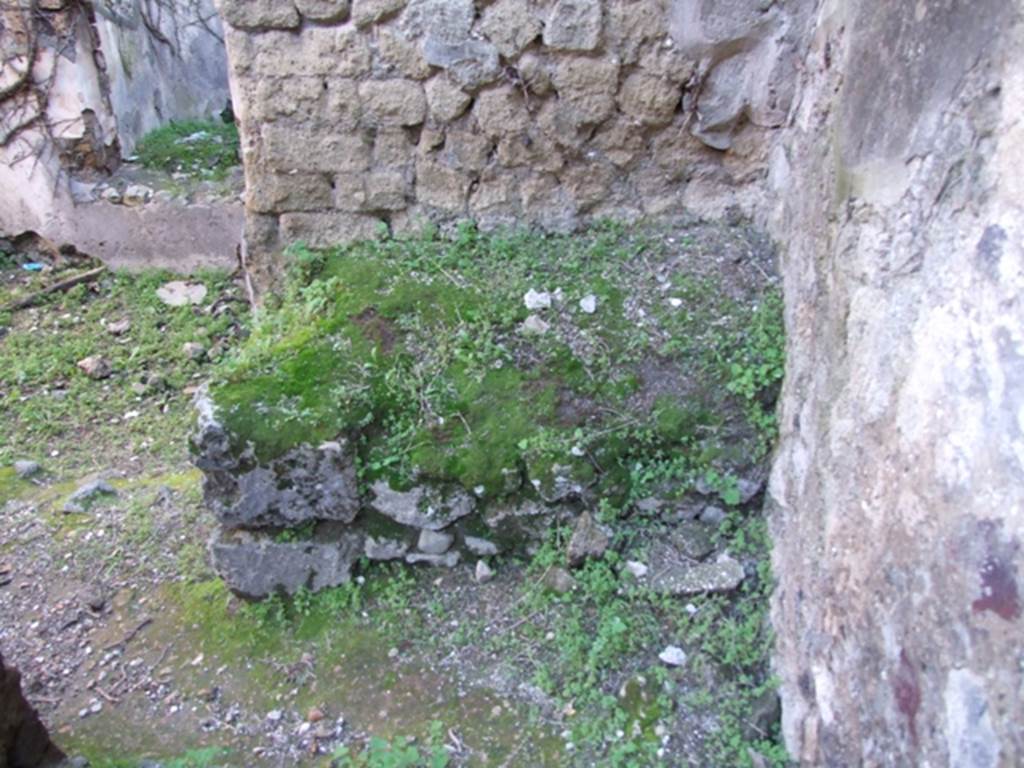 VII.2.14 Pompeii. March 2009. Masonry bench or hearth against south wall of kitchen. According to Boyce, in the west wall of the kitchen is an arched niche called in the report “una nicchia per I lari”. See Boyce G. K., 1937. Corpus of the Lararia of Pompeii. Rome: MAAR 14.  (250, p. 62)