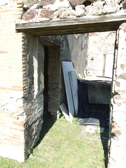 VII.2.16 Pompeii. March 2009.  Doorway in north portico, leading to atrium, and with side door to room 20, triclinium.
