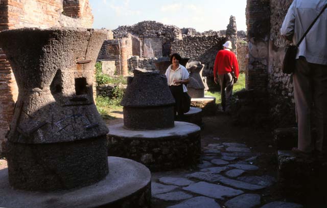 VII.2.22 Pompeii. October 2001. Looking east along mills in bakery. Photo courtesy of Peter Woods.
