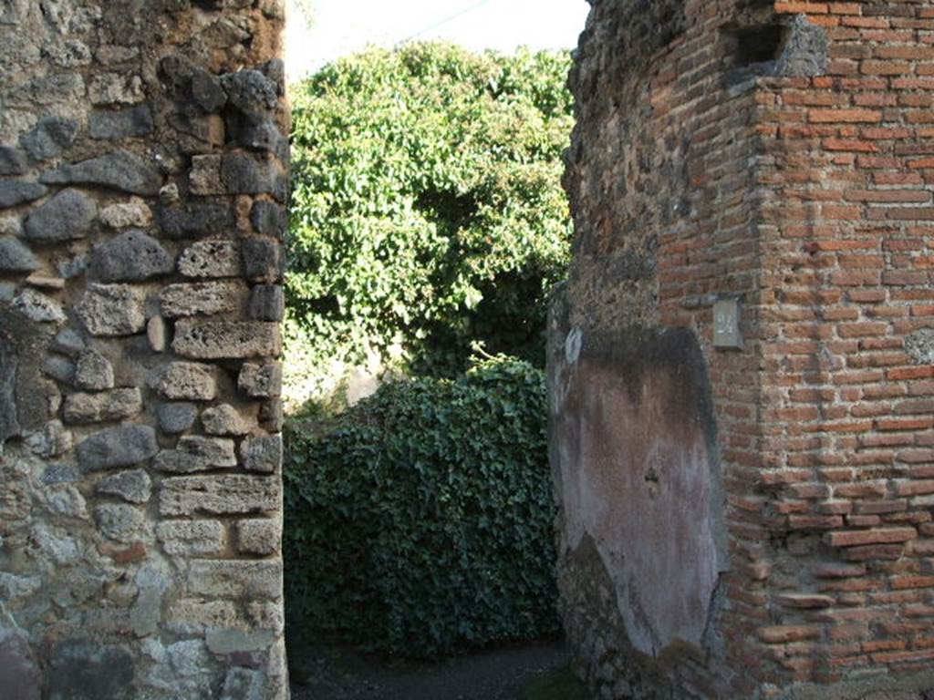 VII.2.24 Pompeii. December 2004. Entrance doorway looking towards south wall.
The wall would have been painted with a black zoccolo (lower part) and a white wall above.
