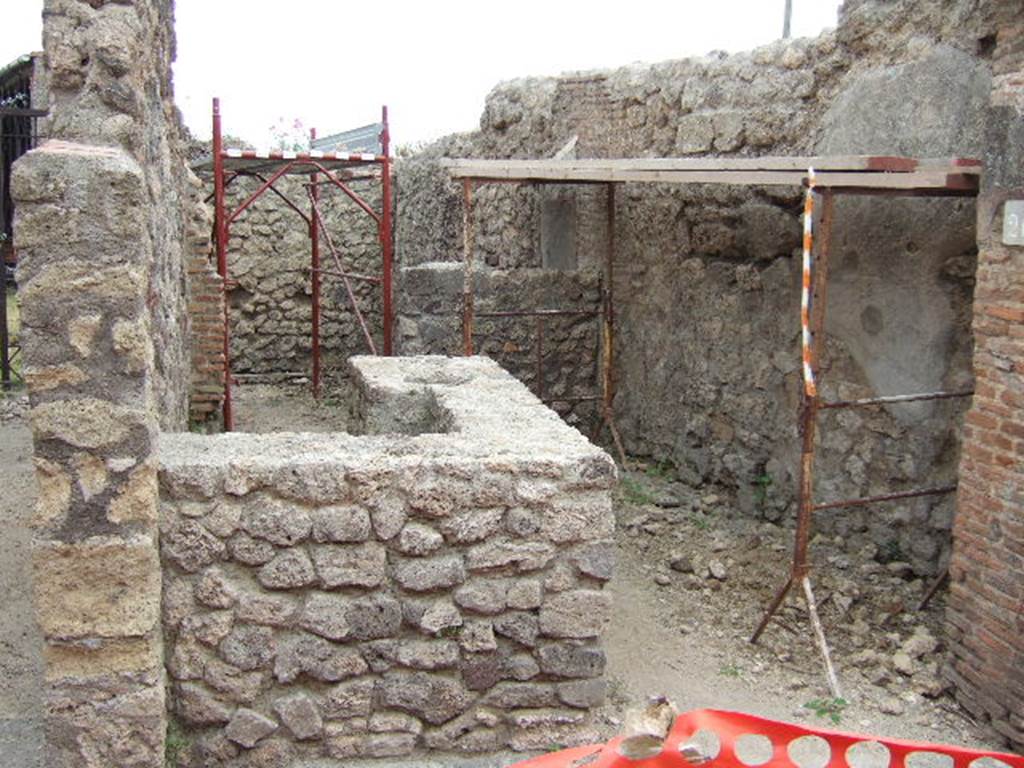 VII.2.26 Pompeii. May 2006. Looking east past restored counter, towards rear room.