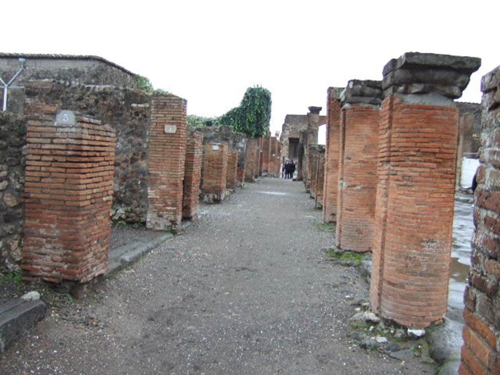 VII.4.3  and  VII.4.4 Pompeii. December 2005. Looking south along portico outside shops on Via del Foro. 

