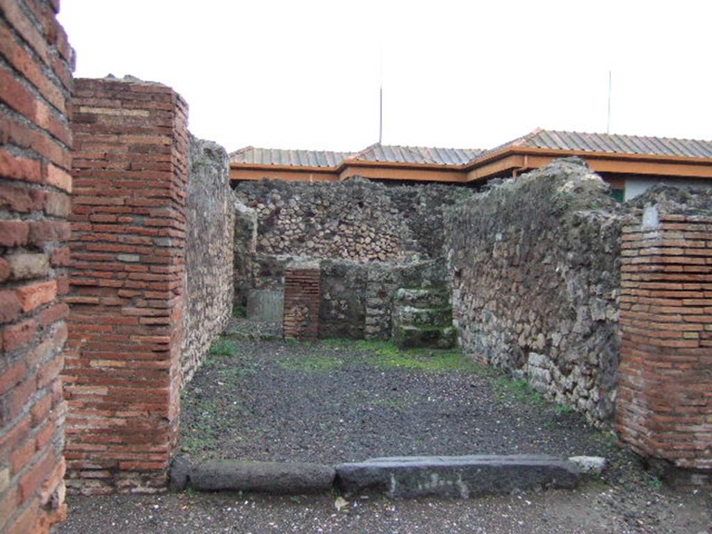 VII.4.3 Pompeii. December 2005. Looking east from entrance. The steps to the upper floor can be seen in the south-east corner of the shop-room, on the right. The doorway to the rear room can be seen in the north-east corner, on the left.  In the rear room, against the east wall, there is a block of tufa stone, found on this was CIL IV 6602.  This block of stone can partly be seen through the doorway. The graffito read -
 M(arcum)  Artor(ium)  II v(irum)  [...]    [CIL IV 6602]
See Varone, A. and Stefani, G., 2009. Titulorum Pictorum Pompeianorum, Rome: L’erma di Bretschneider, (p.355 & photo XXVb)
Eschebach thought it may have been used as a podium ?
See Eschebach, L., 1993. Gebäudeverzeichnis und Stadtplan der antiken Stadt Pompeji. Köln: Böhlau. (p.272)



