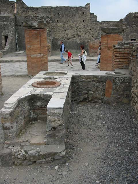 VII.4.4  Pompeii. March 2009. South wall of thermopolium, with doorway to cupboard or small room, under stairs of entrance VII.4.5