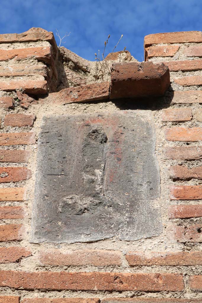 VII.4.27 Pompeii. December 2018. 
Plaque on pillar on west (left) side of entrance. Photo courtesy of Aude Durand.
