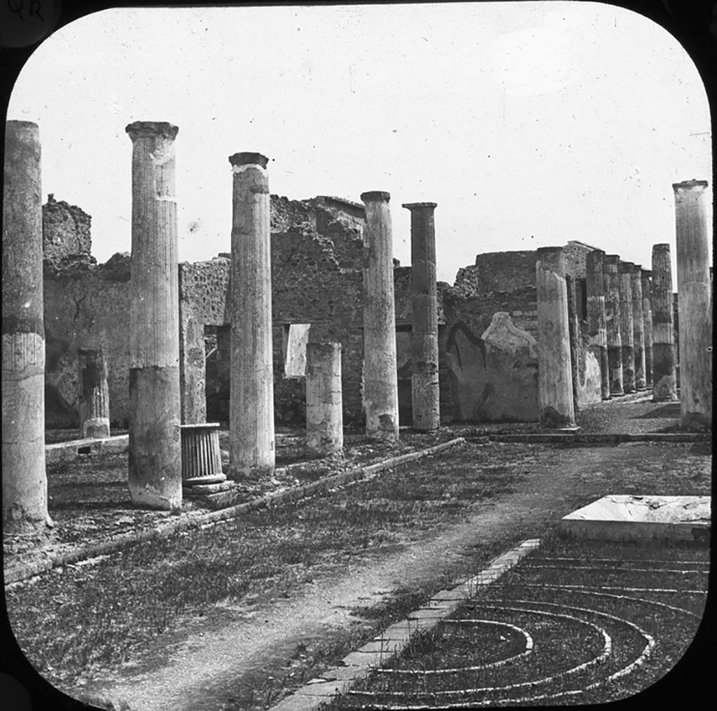 VII.4.31/51 Pompeii. 
Looking south-east from the north-west corner towards the east portico of the north peristyle, showing the brick edged flower-bed.
According to Jashemski, the garden area was divided by a shallow square pool (1.15 x 1.15m) with a marble fountain in the centre.
On each side of the pool was an imperfectly preserved planting bed, consisting of bricks set on edge arranged to form four concentric circles within two rectangles.
Only the west half of the bed to the north of the pool is visible today.
See Jashemski, W. F., 1993. The Gardens of Pompeii, Volume II: Appendices. New York: Caratzas. (p.179-80)
Photo by permission of the Institute of Archaeology, University of Oxford. File name instarchbx202im015. Resource ID. 44484.
See photo on University of Oxford HEIR database
