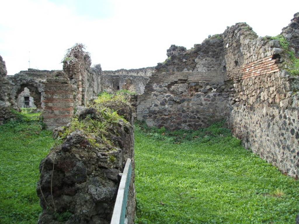 VII.6.16 Pompeii. December 2004. Remains of dividing wall with long room of VII.6.15 (in centre left). 