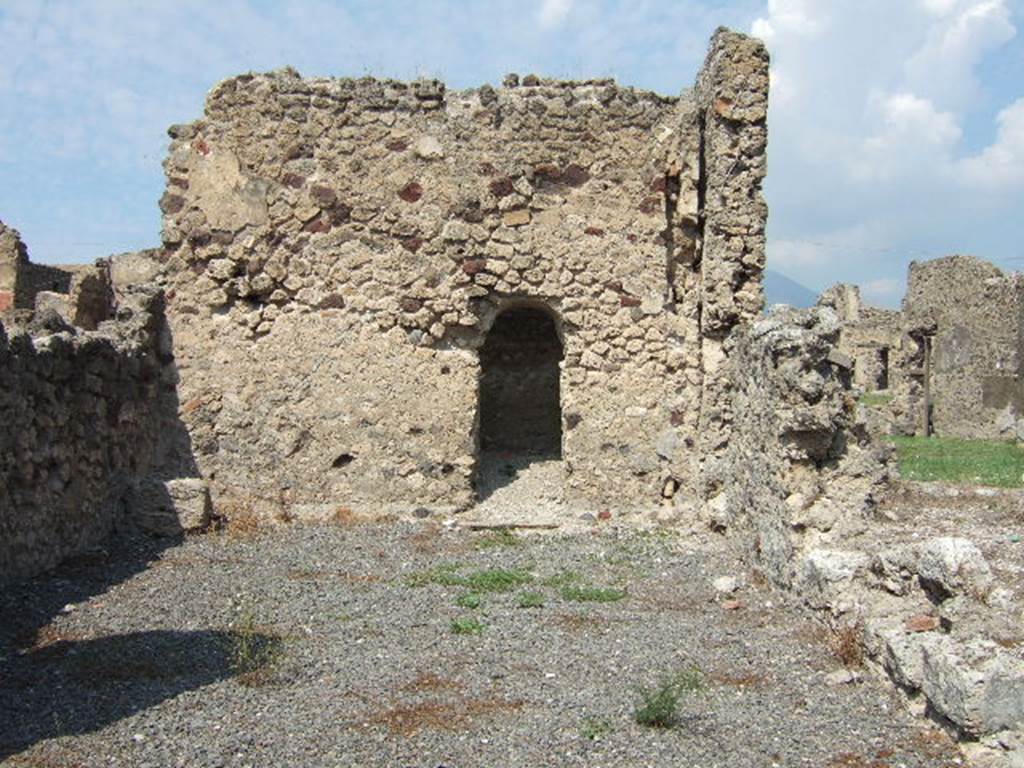 VII.6.29 Pompeii. September 2005. According to Fiorelli and Eschebach, on the left at the rear would have been a staircase to the upper floor. At the rear there was an arched gateway to the latrine, with a nearby downpipe from the upper floor. See Pappalardo, U., 2001. La Descrizione di Pompei per Giuseppe Fiorelli (1875). Napoli: Massa Editore. (p.160). See Eschebach, L., 1993. Gebäudeverzeichnis und Stadtplan der antiken Stadt Pompeji. Köln: Böhlau. (p.296)

According to Garcia y Garcia, a plaster-cast of the door of this shop, made in 1859, had been put on display in the antiquarium. Fortunately drawings were made of it, as it was destroyed in the bombing in 1943. See Garcia y Garcia, L., 2006. Danni di guerra a Pompei. Rome: L’Erma di Bretschneider. (p.107)

According to Varone, found inscribed in the shop, written by an unknown to an unknown love, was –

Venus es.  Ve(nus?)    [CIL IV 1625]

Simply translated as – You are Venus, Venus. 
See Varone, A., 2002. Erotica Pompeiana: Love Inscriptions on the Walls of Pompeii, Rome: L’erma di Bretschneider. (p. 30)

