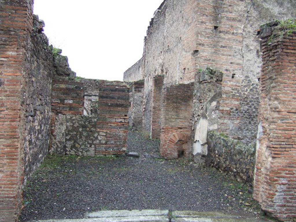 VII.9.27 Pompeii. December 2005. Looking south across shop towards rear rooms and doorway linking to VII.9.40/41. According to Jashemski, this narrow shop-house, which reached through the entire insula, had a large shop fronting onto Via degli Augustali. At the rear of the shop area, was a garden which was visible both from the house and the street, through the very wide opening in the rear room of the shop. 
See Jashemski, W. F., 1993. The Gardens of Pompeii, Volume II: Appendices. New York: Caratzas. (p.189)
