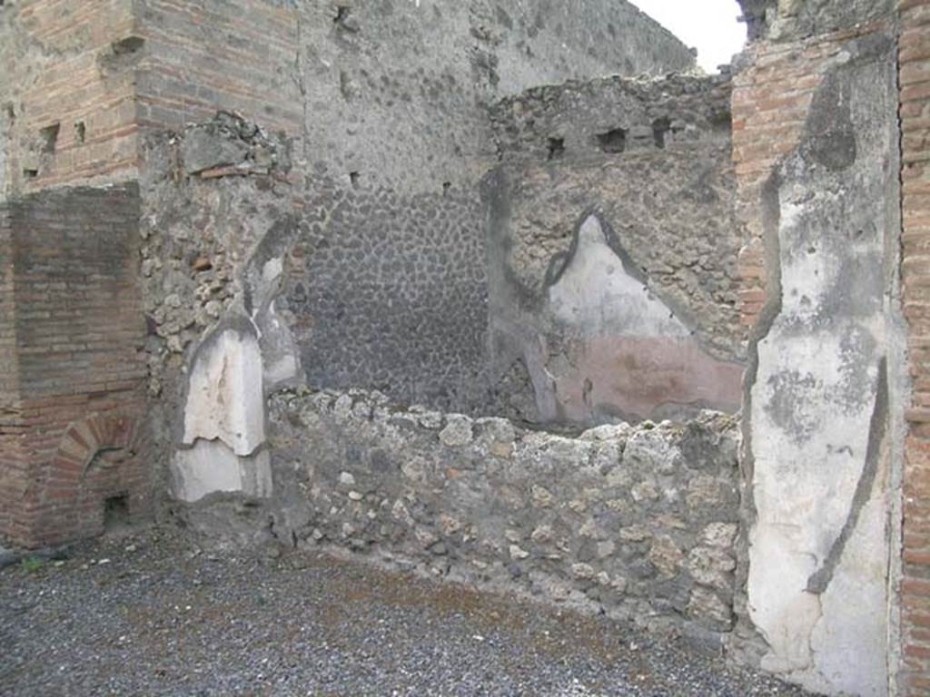 VII.9.27 Pompeii. September 2005. 
Looking towards structure in south-west corner of shop-room, the area behind the small wall is VII.9.26.
Photo courtesy of Nicolas Monteix.
