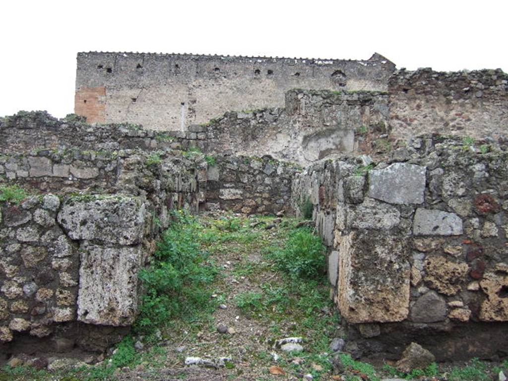 VII.9.35 Pompeii. December 2005. Looking west into entrance doorway to site of steps to upper floor. Nearby would have been a latrine.
