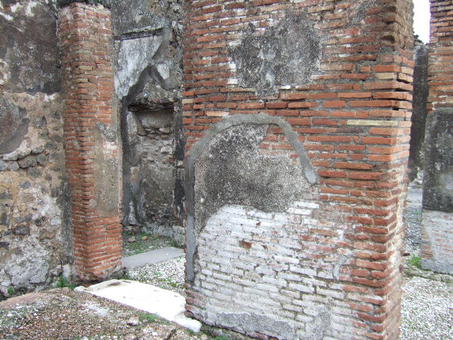 VII.10.5 Pompeii. December 2005. North-east corner of either the atrium, or ala on north side of atrium. On the left, doorway looking through into doorway of cubiculum, on north side of peristyle. On the right side of the pilaster, one of the two entrances from the atrium to the peristyle. 


