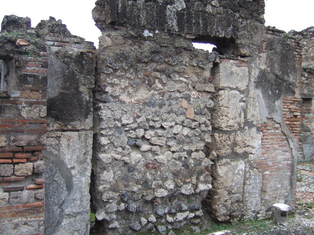 VII.10.5 Pompeii. December 2005. Wall and blocked doorway to atrium, in south-west corner of peristyle.  