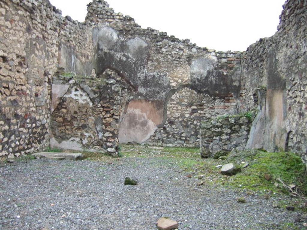 VII.10.6 Pompeii. December 2005. Looking east across shop towards doorway to rear room.
In the north-east corner of the shop-room (on left) can be seen the remains of the base of steps to upper floor.
According to Amoroso, the floor of the shop was simple cocciopesto, whereas the rear room’s floor was the same flooring made with scattered polychrome pieces, similar to the adjacent atrium (of VII.10.5), of which this room had once been part. The walls of the two rooms were plastered with plaster without colour.
Studi della Soprintendenza archeologica di Pompei, 22: l”Insula VII, 10 di Pompei , by Angelo Amoroso. (p.69)

