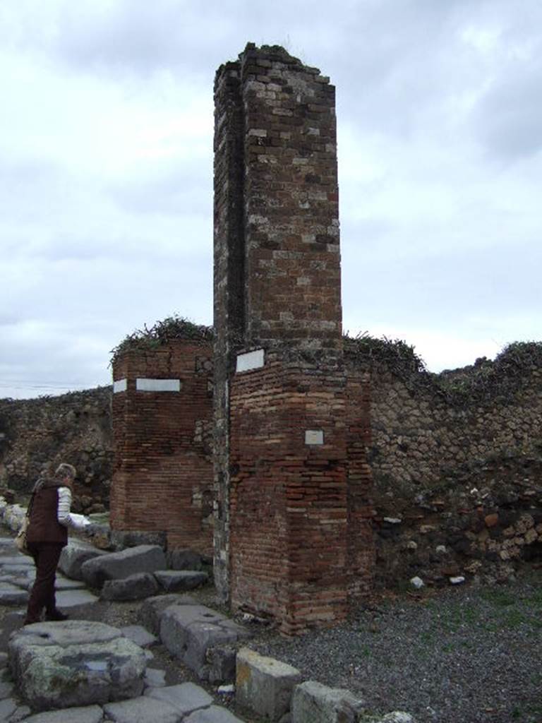 VII.10.7 Pompeii. December 2005. Water tower on north side of workshop. Looking north along Vicolo di Eumachia