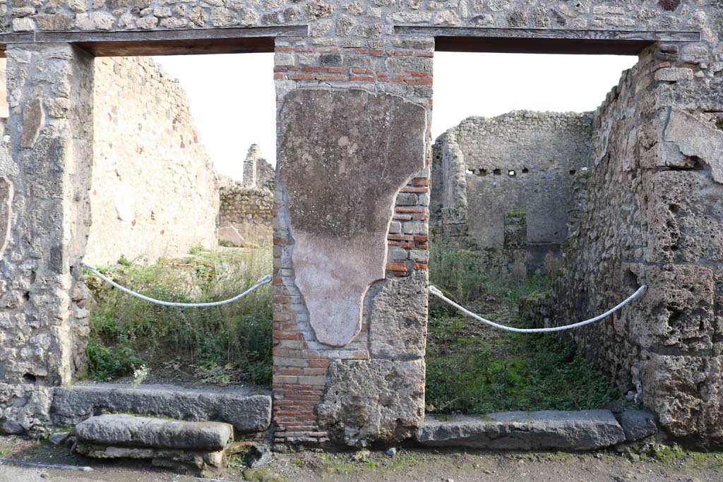 VII.11.3, Pompeii, on left. December 2018. Looking east to entrance doorways, with VII.11.2, on right. Photo courtesy of Aude Durand.

