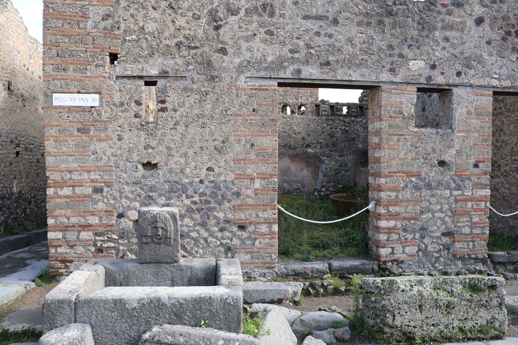 VII.11.5, Pompeii. December 2018. Looking east to entrance doorway at rear of fountain. Photo courtesy of Aude Durand.