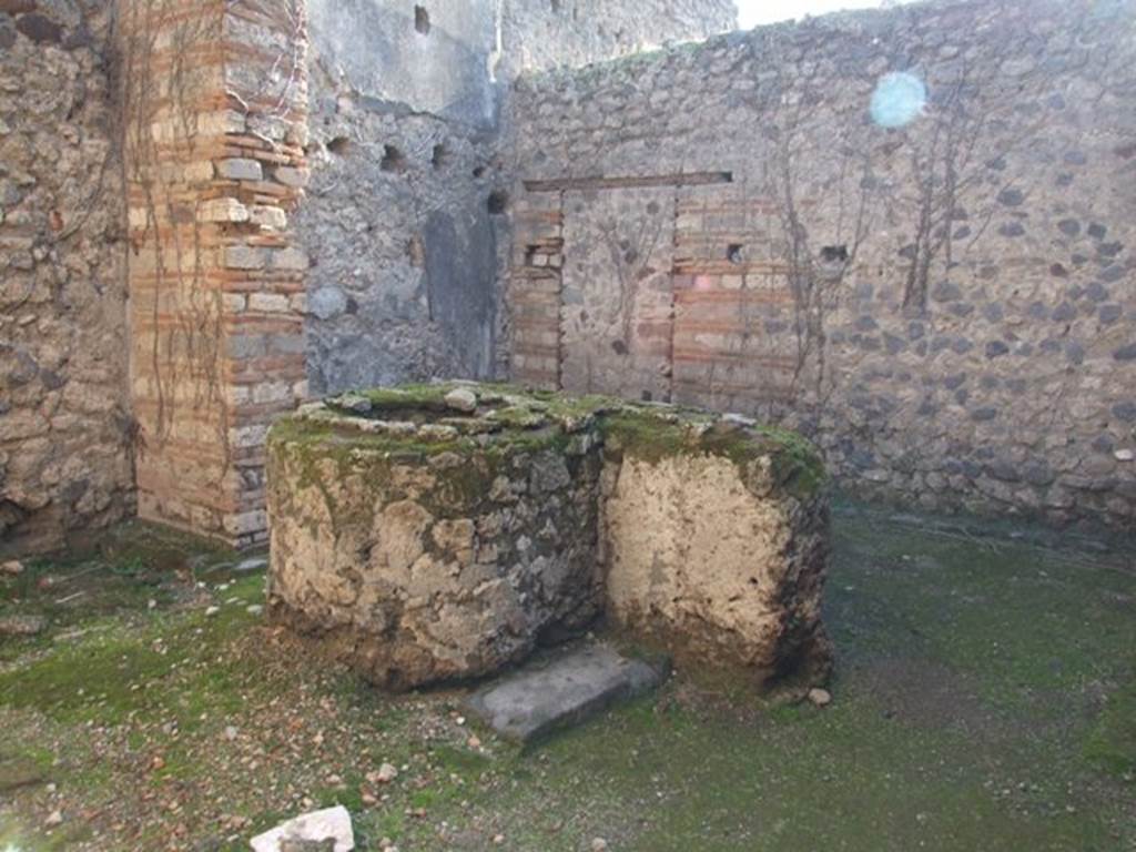 VII.11.7 Pompeii. December 2007. Looking south-east across masonry trough to back room.
According to PPM, the door to the house at number 6, later closed in opus incertum, is located in the south wall.
In the east wall are the holes for the floor joists and remains of the decoration, now faded, of the first floor.
See Carratelli, G. P., 1990-2003. Pompei: Pitture e Mosaici.  Roma: Istituto della enciclopedia italiana., VII, p. 453-5.
