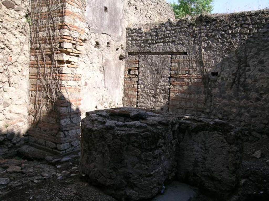 VII.11.7 Pompeii. June 2005. Looking south-east across masonry trough towards south wall and blocked doorway to VII.11.6. Photo courtesy of Nicolas Monteix.
