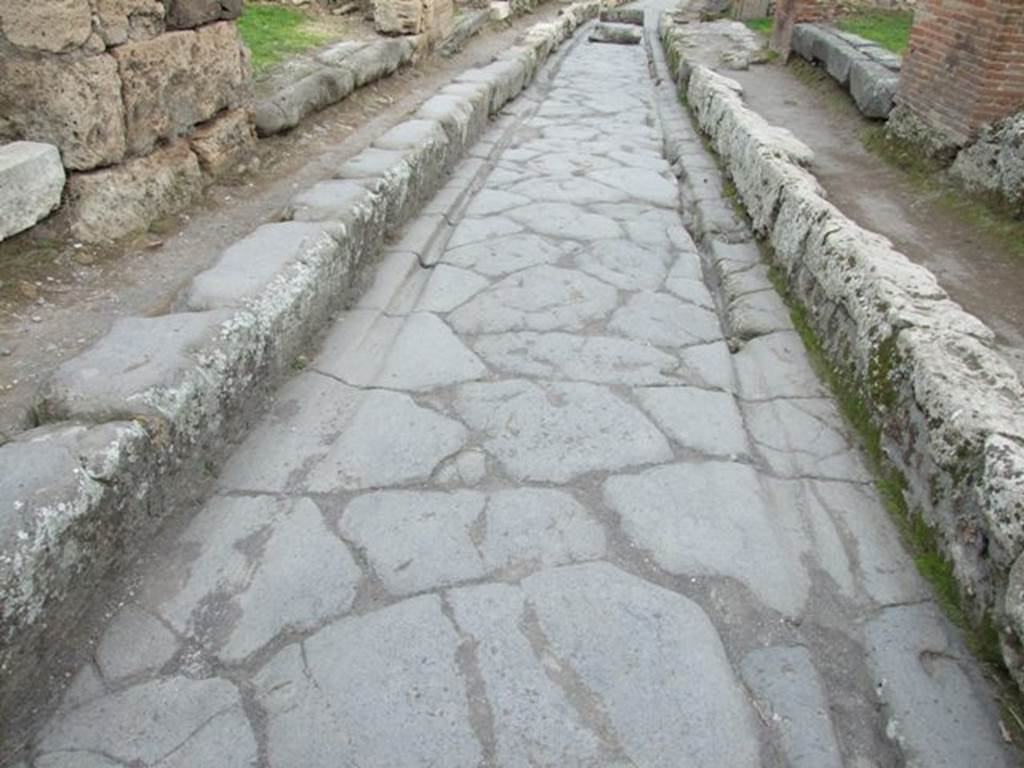 Outside VII.12.4 Pompeii.  December 2007.  Via degli Augustali looking east, with grooves worn by traffic.