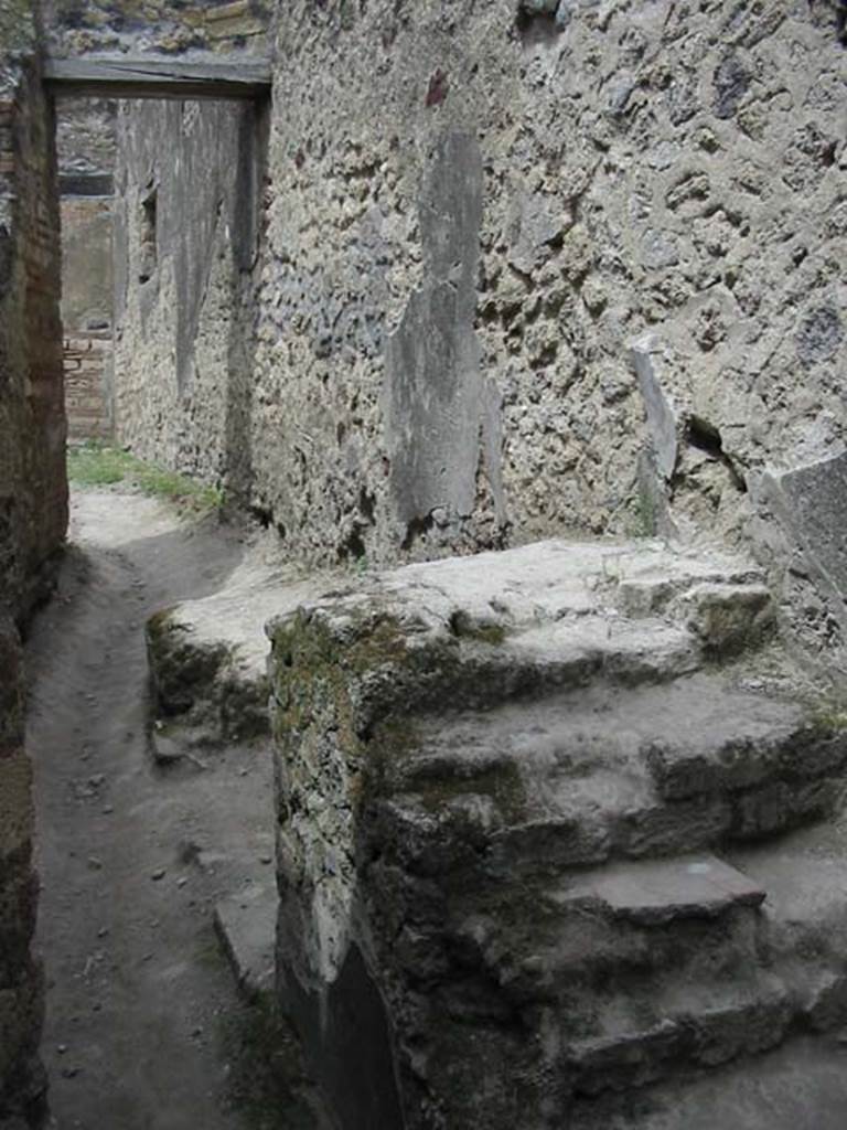 VII.12.16 Pompeii. May 2003. Looking north to corridor to VII.12.15, and steps to upper floor, near east wall. Photo courtesy of Nicolas Monteix.
