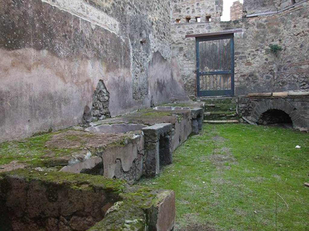 VII.12.17 Pompeii. December 2006. Looking west across south side, towards two round water basins set in podium. 

