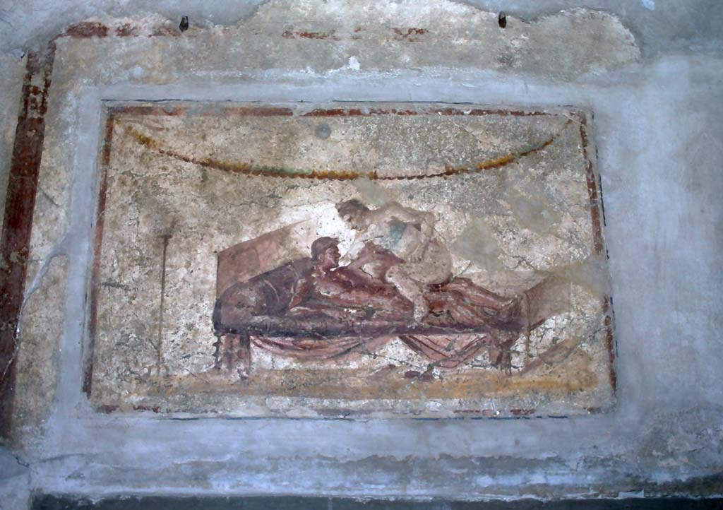 VII.12.18 Pompeii. The Lupanare. December 2006. Erotic wall painting on frieze.