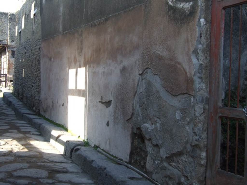 VII.12.23 Pompeii. December 2007. Plaster on street wall to left of entrance doorway.