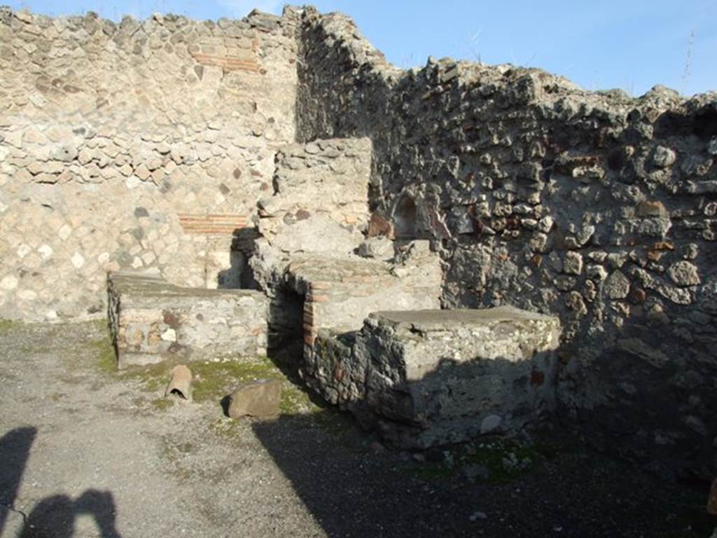 VII.13.7 Pompeii. December 2007. North-east corner of the dwelling, with lararium niche and masonry water basin in the corner.