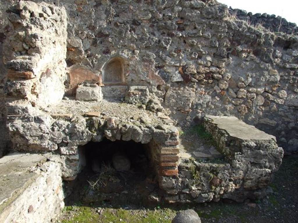 VII.13.7 Pompeii. December 2007. Niche and hearth on east wall of dwelling.