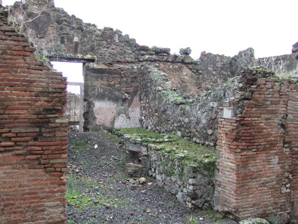 VII.13.21 Pompeii. December 2005. Looking south-east towards entrance doorway and across masonry podium.