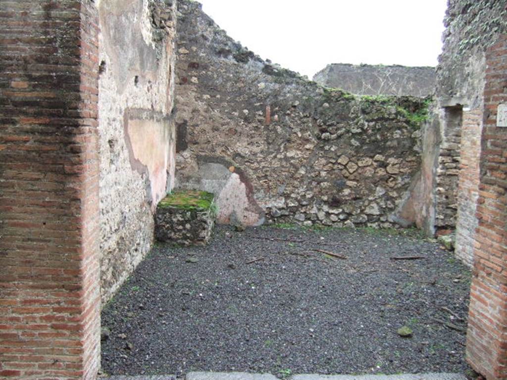 VII.13.23 Pompeii. December 2005. Looking east across shop, in the south wall (on the right) is the doorway into a side-room.
