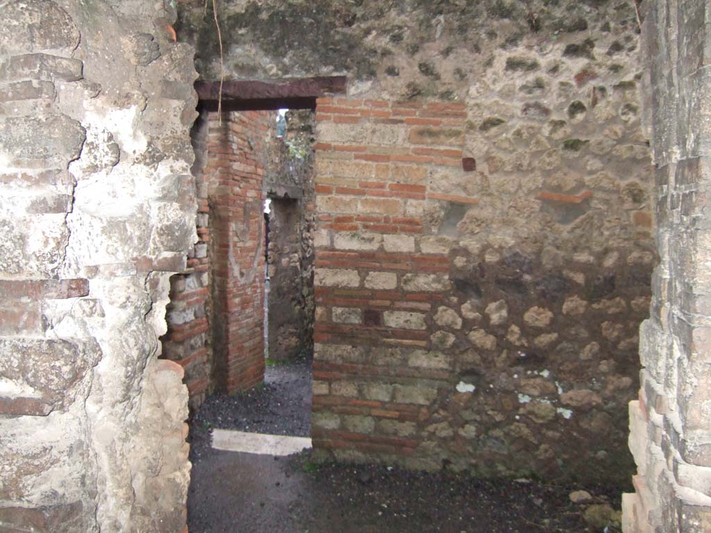 VII.14.9 Pompeii. December 2005. Room 10, south wall with doorway from room 10 into room 9, with corridor room 6, ahead.