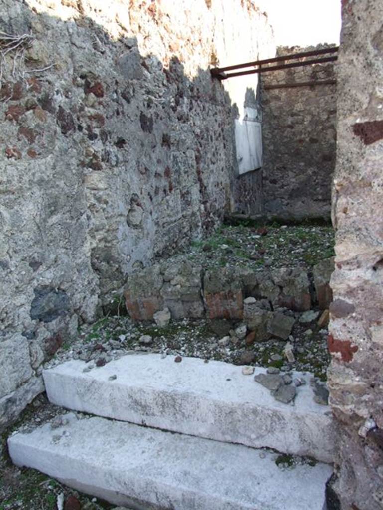 VII.15.2 Pompeii. December 2007. Looking south. Room on western side of house accessed by two marble steps.  The room was built at a slightly higher level than the other ground level rooms. This was to accommodate the ramp descending to the subterranean rooms.

