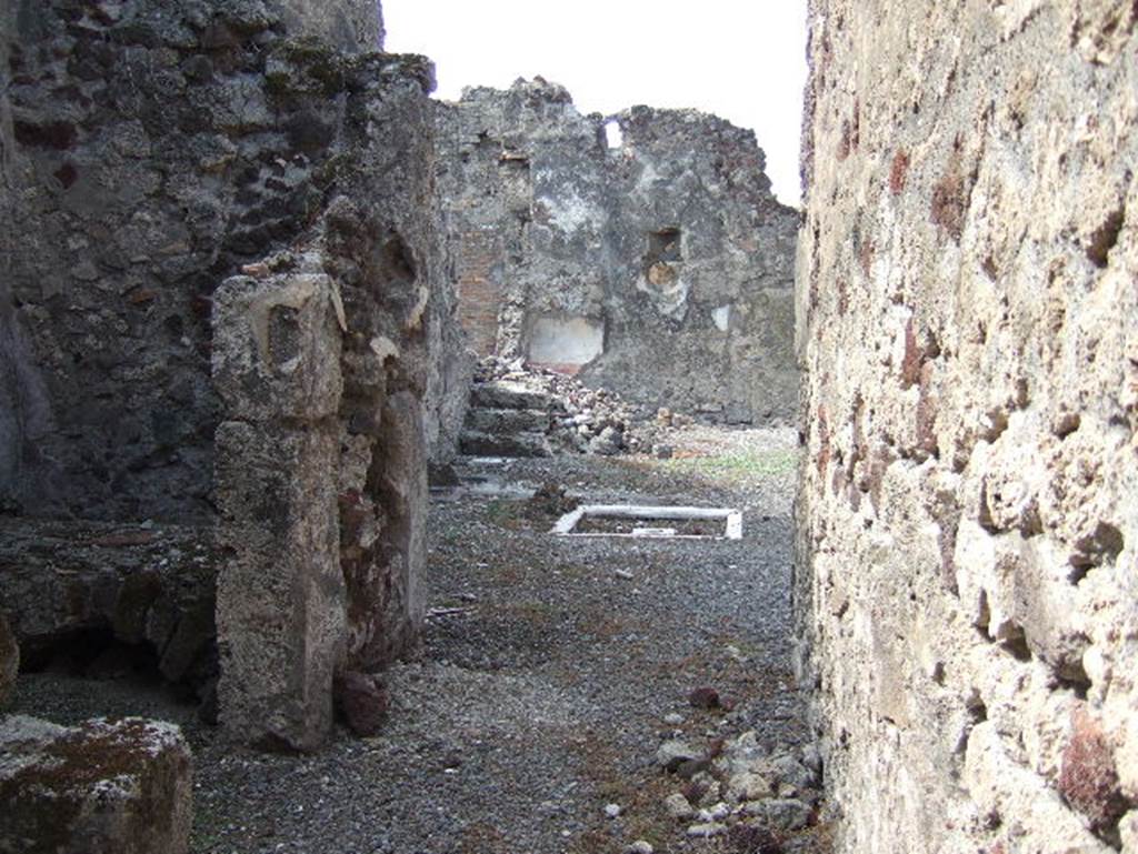 VII.15.9 Pompeii. September 2005. Looking west across atrium towards steps to upper floor in south-west corner, and rear rooms.
