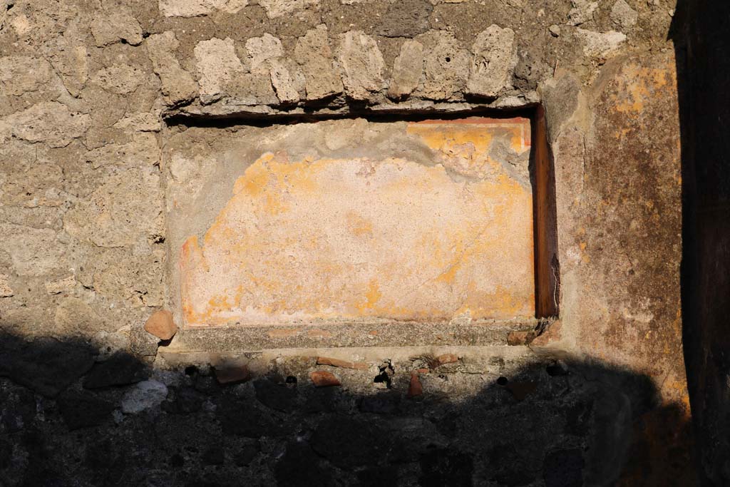 VII.15.12 Pompeii. March 2018. Looking east across room described as “central atrium-like room” or triclinium.
Foto Taylor Lauritsen, ERC Grant 681269 DÉCOR.
 According to Boyce, in the east wall of the central atrium-like room was a shallow, rectangular niche of unusual proportions.
Its walls were coated with yellow stucco and decorated with red stripes; the Bull. Inst. referred to it as “forse un larario”.
See Bullettino dell’Instituto di Corrispondenza Archeologica (DAIR), 1874, 71.
See Boyce G. K., 1937. Corpus of the Lararia of Pompeii. Rome: MAAR 14. (p.72, no.333).



