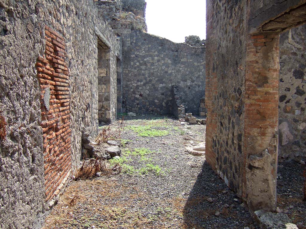 VII.15.14 Pompeii. September 2005. Looking south towards remains of kitchen area in corridor, on left.
On the right is a doorway from the shop at VII.15.15, with the garden area at its rear.
