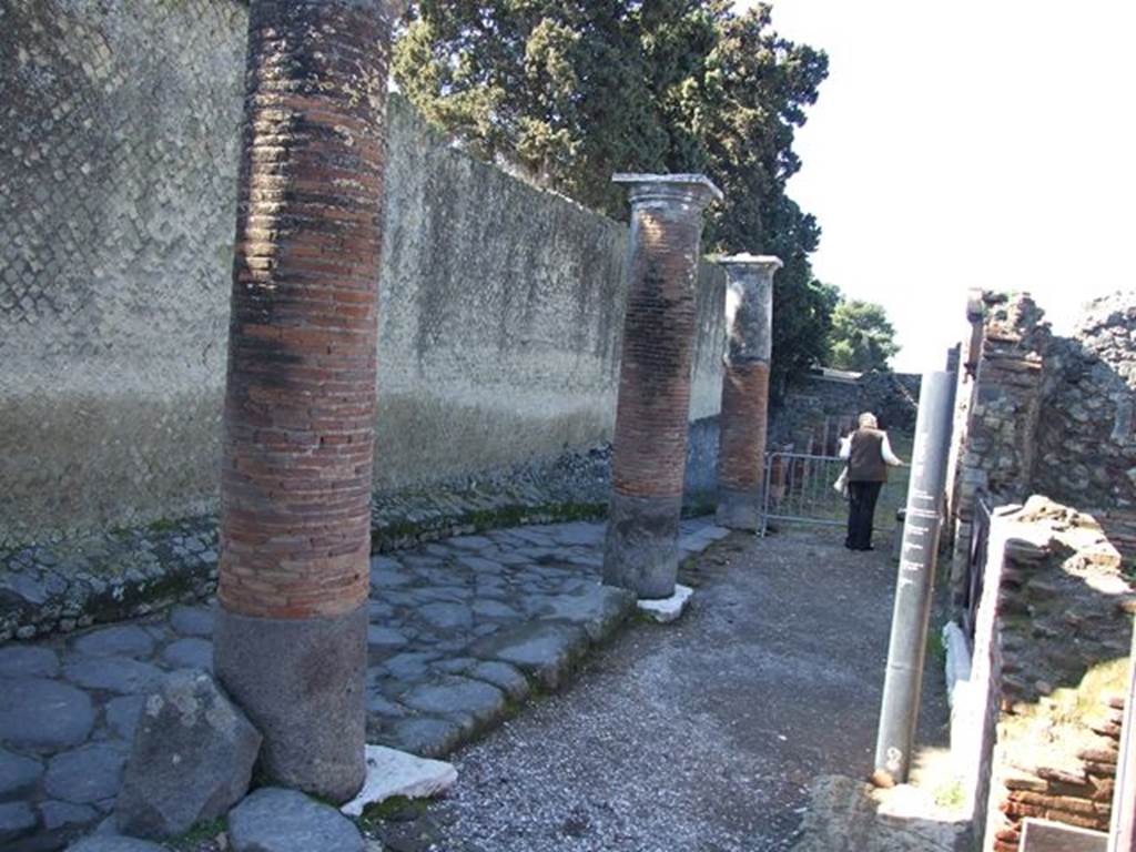 Pompeii. March 2009. Temple of Venus, on left. North Wall of Temple, and remains of large portico on Via Marina. Looking west.

