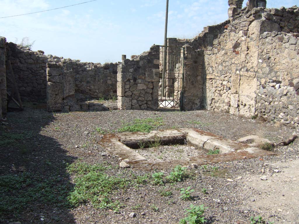 VII.16.12 Pompeii. September 2005. Room 24, looking west across atrium. At the rear of the atrium are two rooms. On the left is room 26 which was a cubiculum. In the centre is room 25, a closed tablinum. On the right is area 27, with entry to lower rooms. On the left side of the atrium, according to Eschebach, ther would have been steps to the upper floor. See Eschebach, L., 1993. Gebäudeverzeichnis und Stadtplan der antiken Stadt Pompeji. Köln: Böhlau. (p. 348).